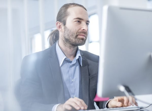 Businessman in office working on a computer